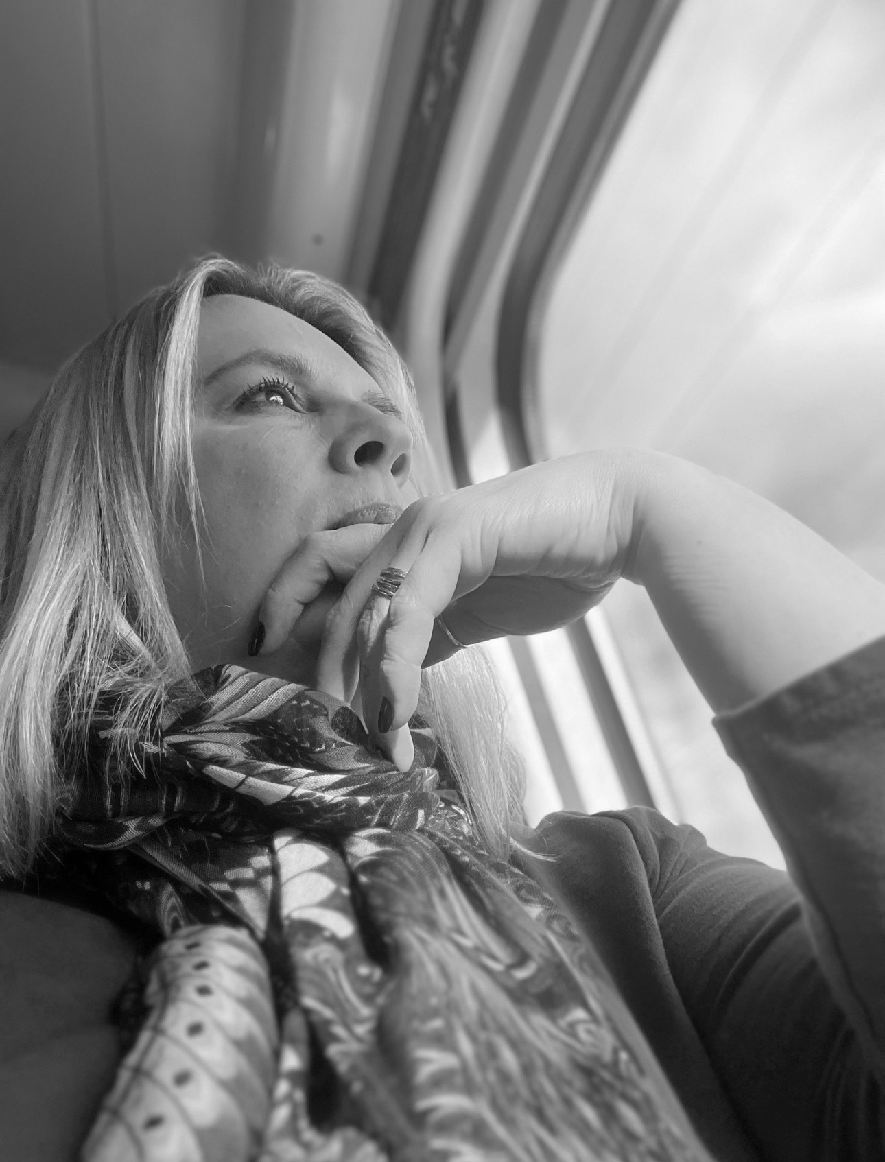 Leanne Lorains reflecting while looking out of a train window